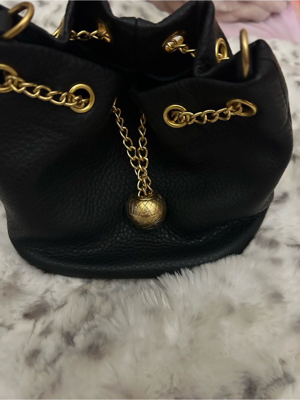Black Leather Drawstring Bucket Bag with Gold Chain Accents